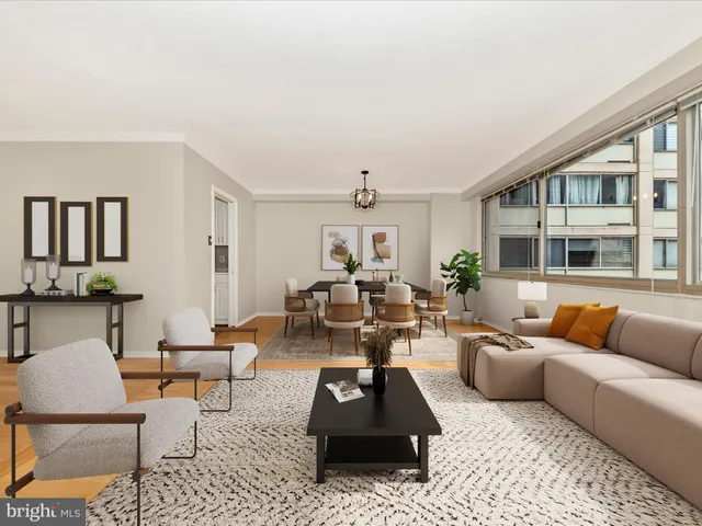 a living room with furniture a rug and a chandelier