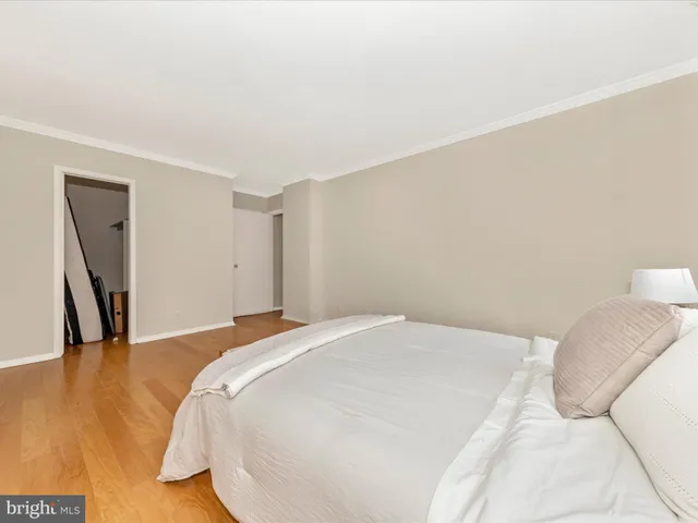 a bedroom with a bed and a large mirror