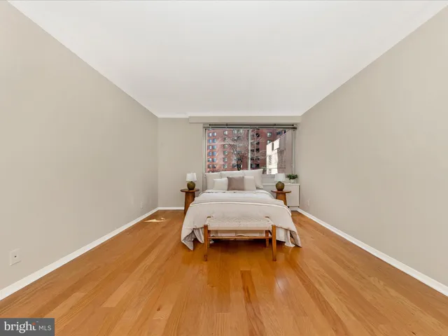 a room with a bed and wooden floor