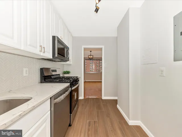 a kitchen with stainless steel appliances granite countertop a stove and a sink