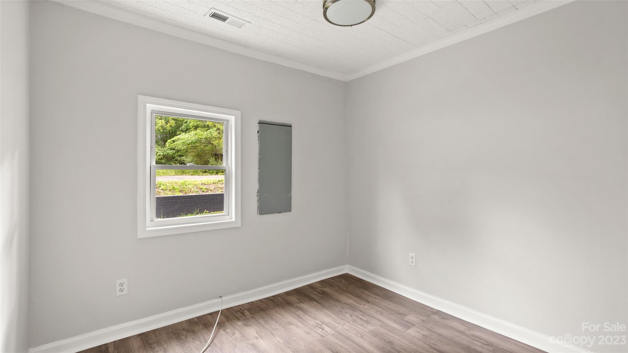 705 Sumter Street Lancaster, SC 29720 - Photo 13 of 16 a view of an empty room with wooden floor and a window