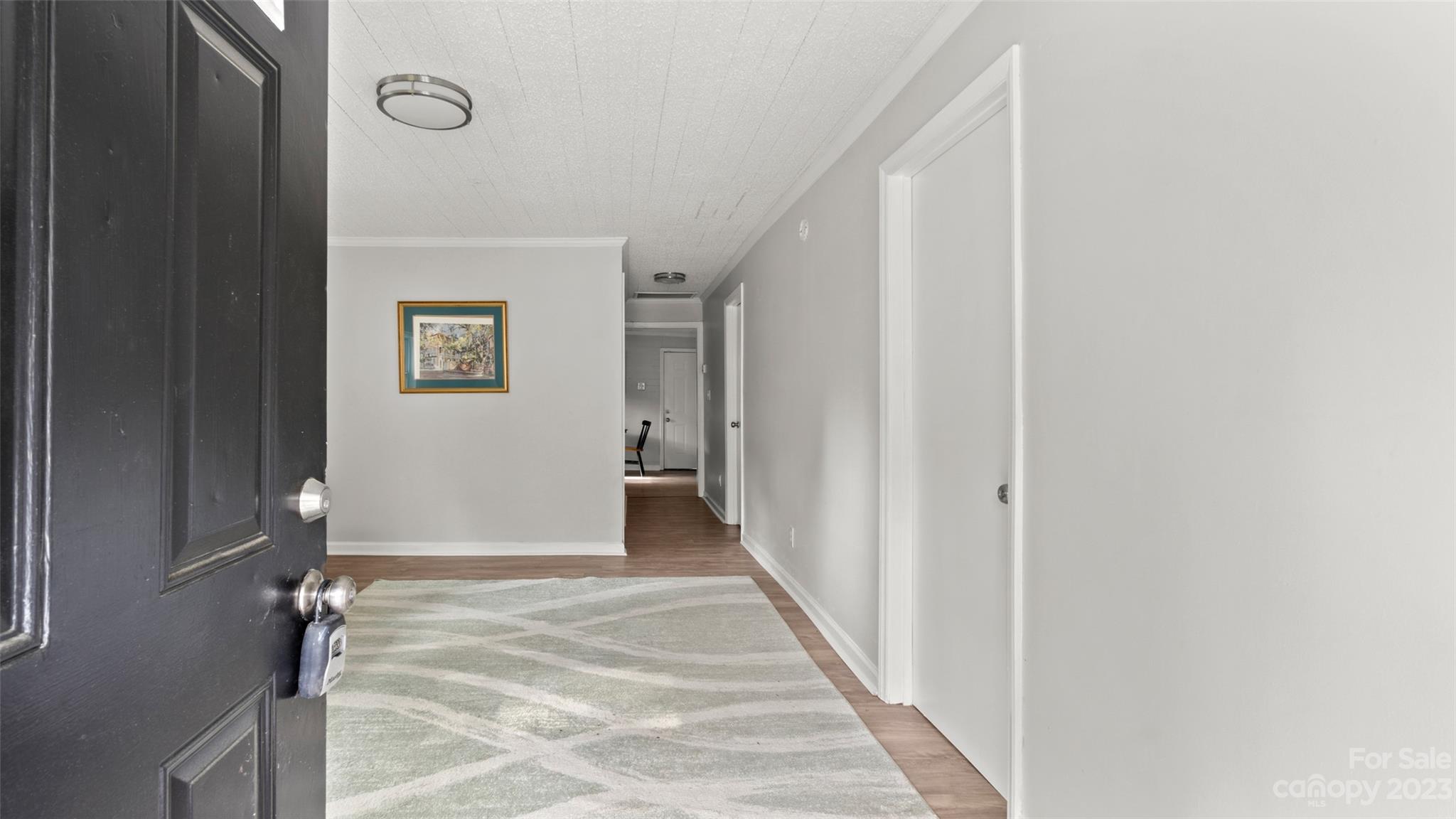 705 Sumter Street Lancaster, SC 29720 - Photo 3 of 16 a view of a hallway with wooden floor and a bathroom