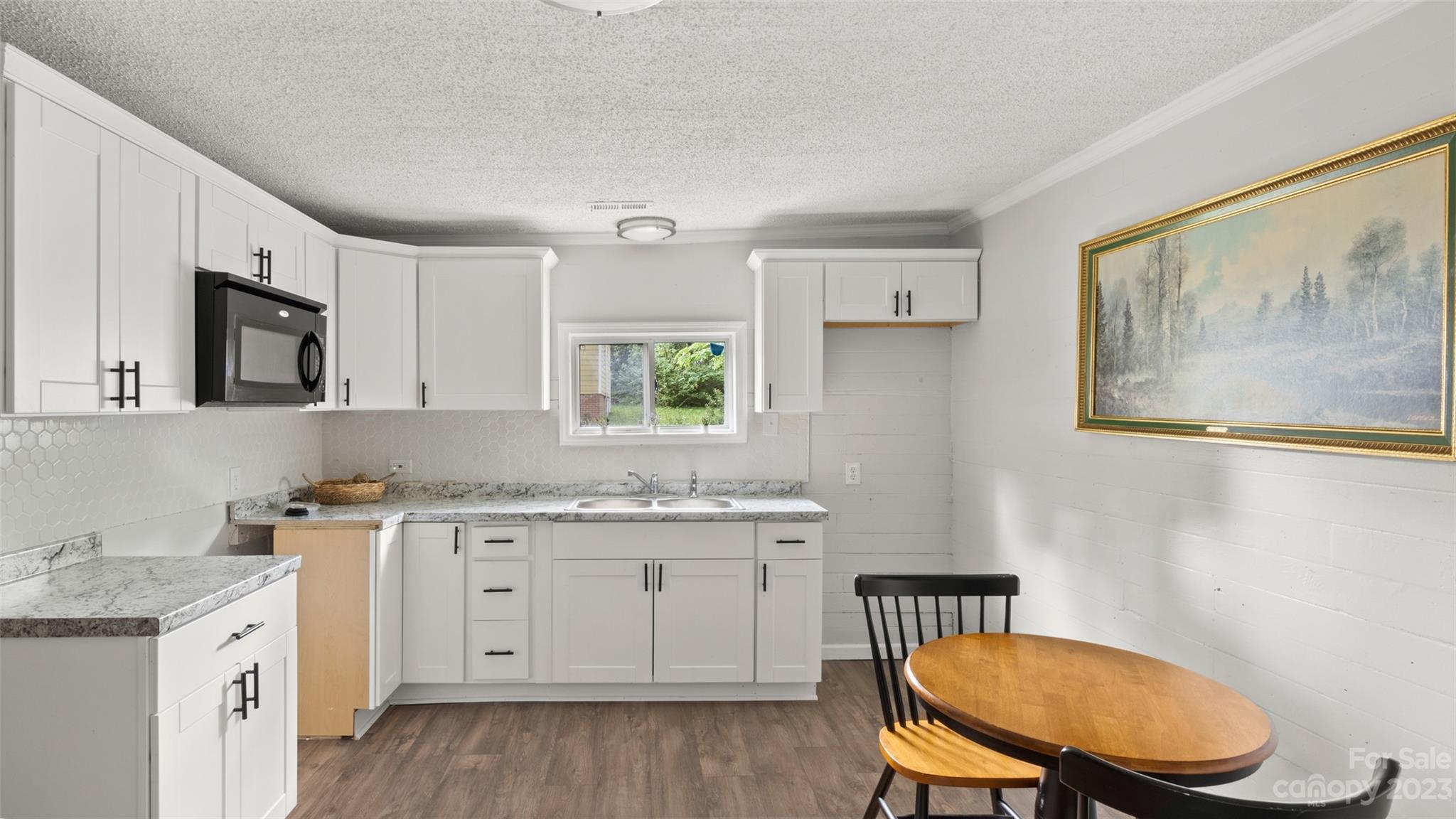 705 Sumter Street Lancaster, SC 29720 - Photo 4 of 16 a kitchen with a sink cabinets and wooden floor
