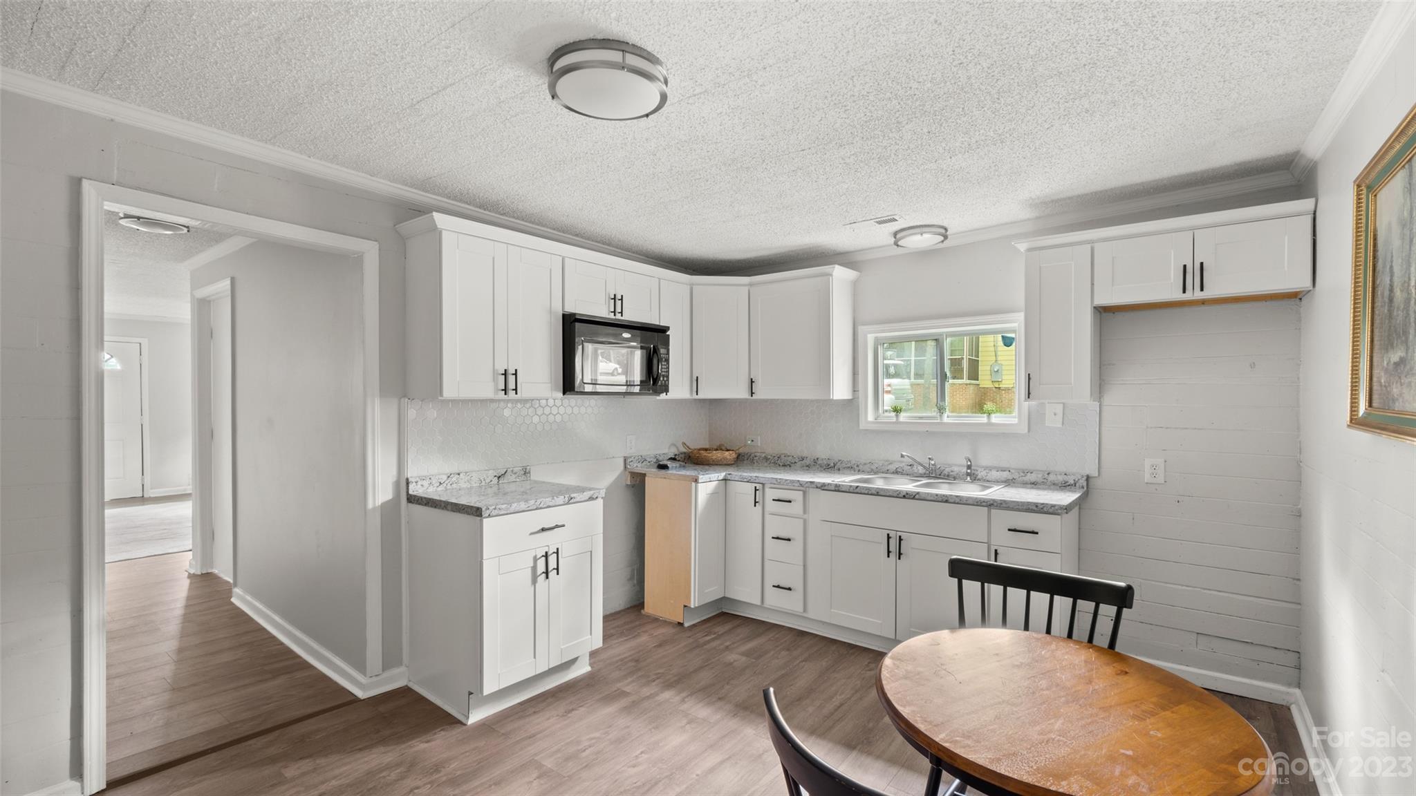 705 Sumter Street Lancaster, SC 29720 - Photo 5 of 16 a kitchen with a stove a sink and a refrigerator