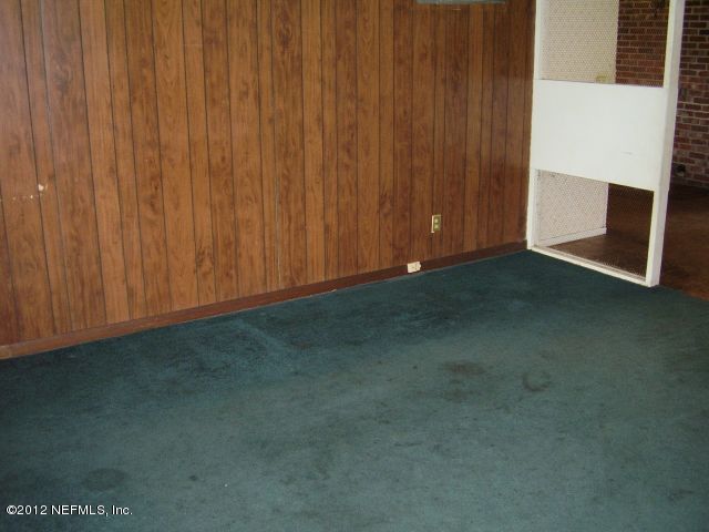 5721 Beney Road Jacksonville, FL 32207 - Photo 2 of 11 a view of an empty room with a wooden door