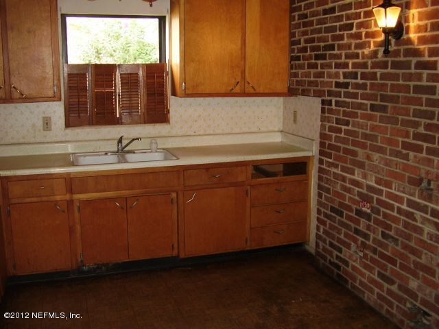 5721 Beney Road Jacksonville, FL 32207 - Photo 4 of 11 a bathroom with a sink and a mirror