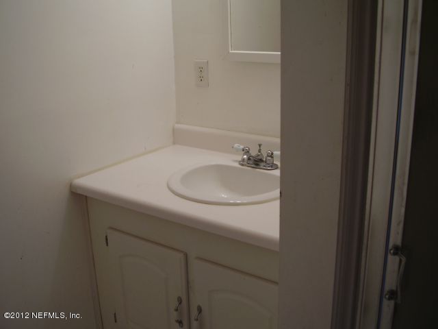 5721 Beney Road Jacksonville, FL 32207 - Photo 9 of 11 a bathroom with a sink and a vanity