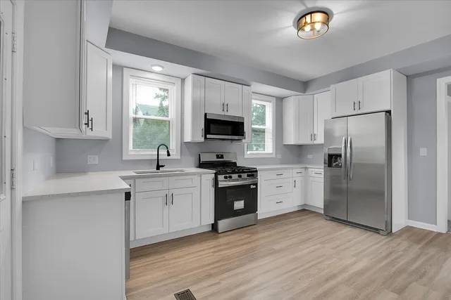 a kitchen with a refrigerator stove and microwave