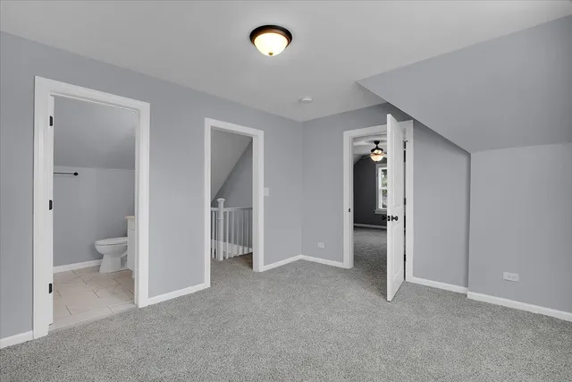 a view of an empty room and a bathroom