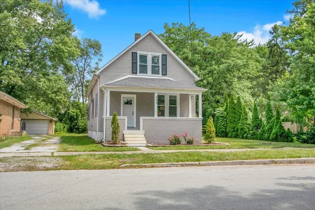 a front view of a house with a garden
