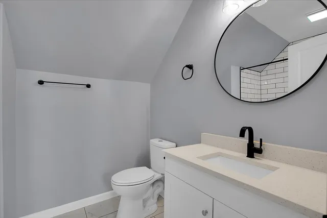 a bathroom with a sink toilet and mirror