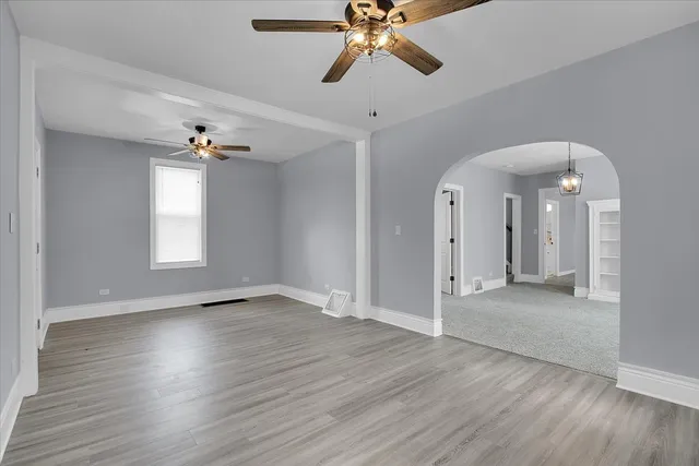 a view of an empty room and wooden floor