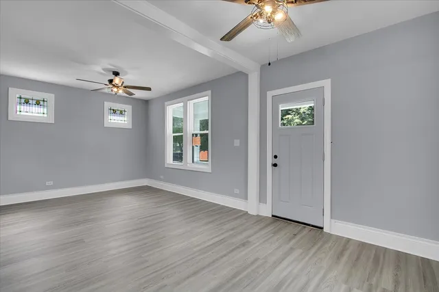 wooden floor in an empty room with a window