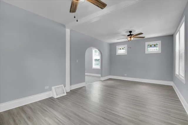 wooden floor in an empty room with a window
