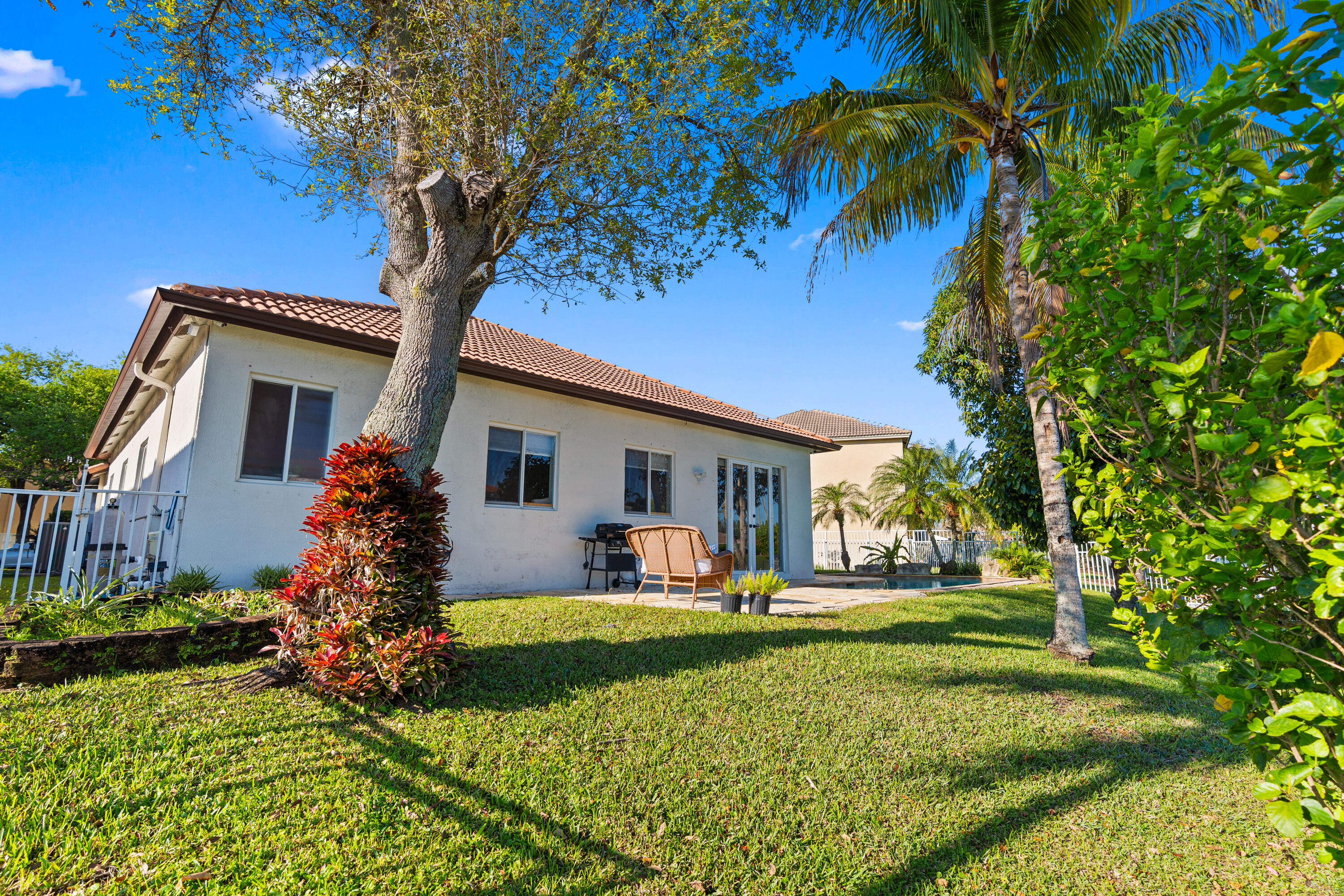 13461 Southwest 29th Street Miramar, FL 33027 - Photo 7 of 54 a front view of house with a garden and trees