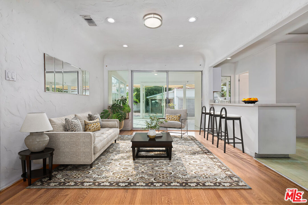 155 Le Doux Road Beverly Hills, CA 90211 - Photo 4 of 12 a living room with furniture and a rug