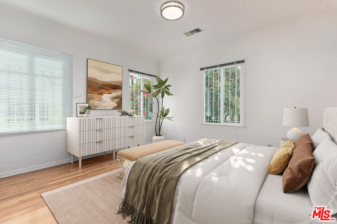 155 Le Doux Road Beverly Hills, CA 90211 - Photo 6 of 12 a bedroom with a bed and window