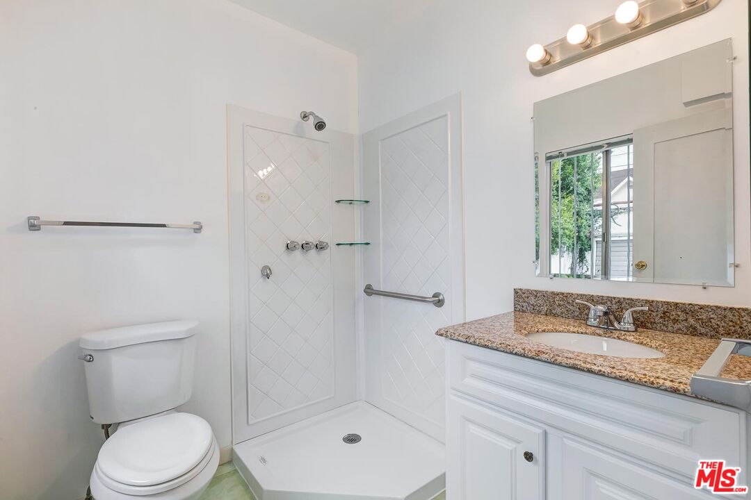 155 Le Doux Road Beverly Hills, CA 90211 - Photo 8 of 12 a bathroom with a granite countertop sink a toilet and shower