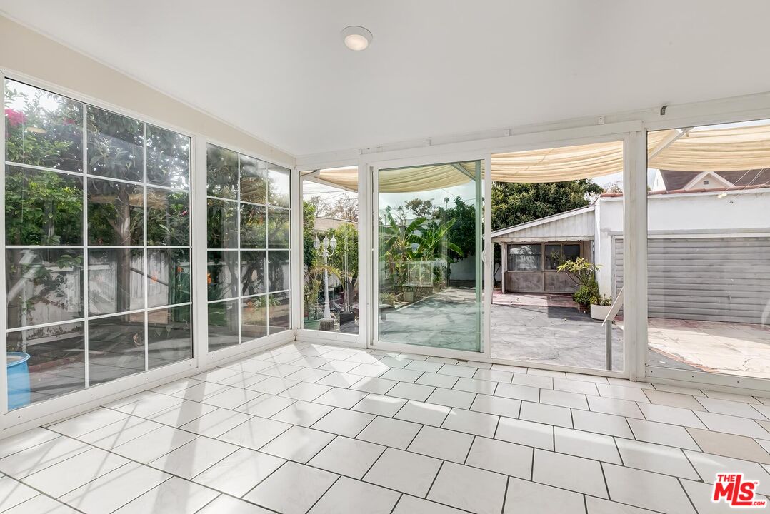 155 Le Doux Road Beverly Hills, CA 90211 - Photo 9 of 12 a view of empty room with wooden floor and fan