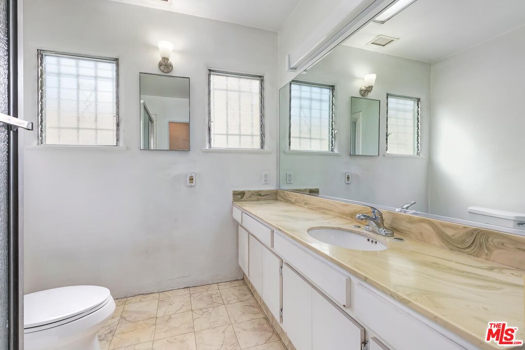155 Le Doux Road Beverly Hills, CA 90211 - Photo 10 of 12 a bathroom with a granite countertop sink mirror vanity and toilet