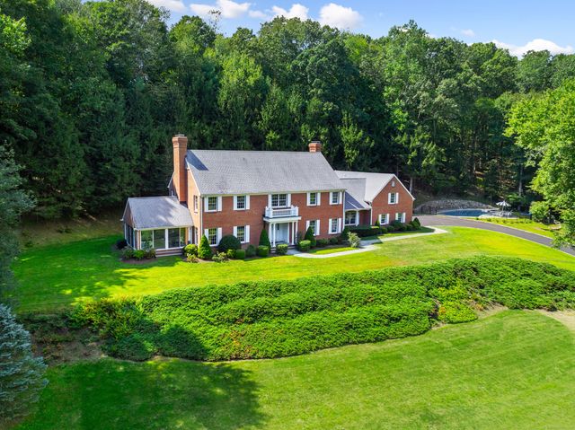a aerial view of a house with swimming pool and big yard