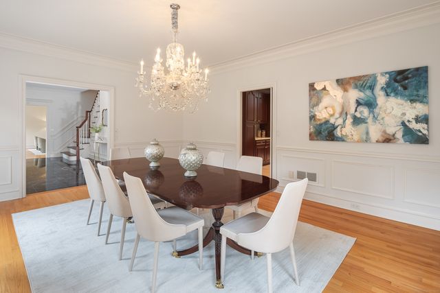a view of a dining room with furniture wooden floor and a chandelier