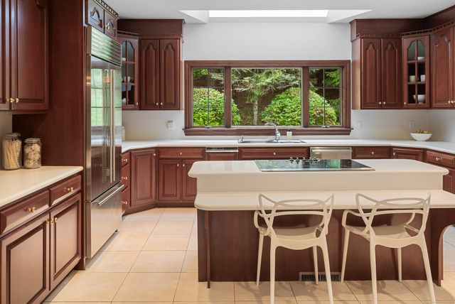 a kitchen with a stove a sink and a refrigerator