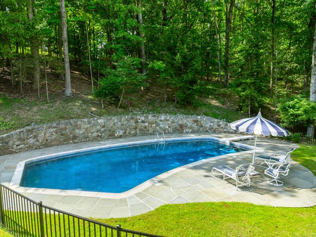 a view of a swimming pool with a patio