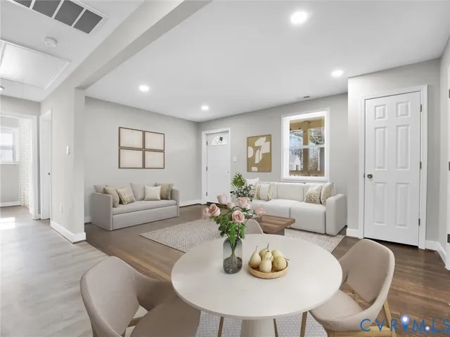 a living room with furniture kitchen and a table