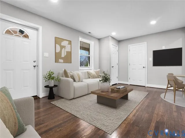 a living room with furniture and wooden floor