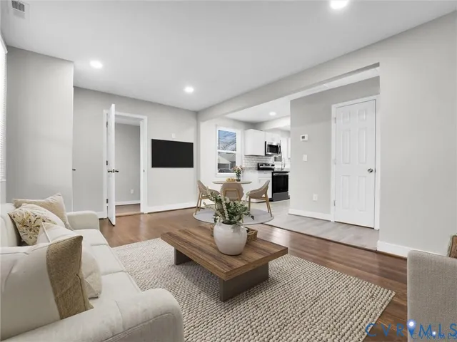 a living room with furniture or couch and a potted plant
