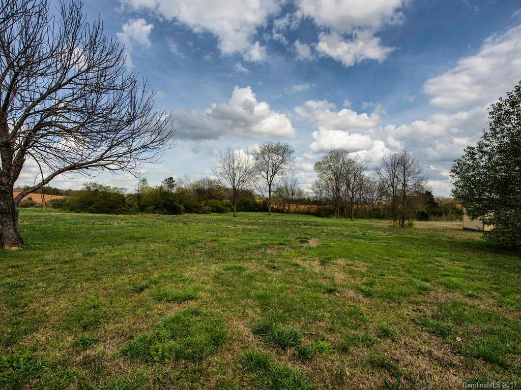 5117 Austin Road Monroe, NC 28112 - Photo 16 of 19 a view of a field of grass and trees