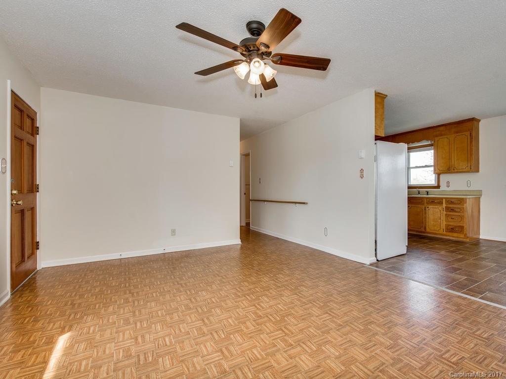5117 Austin Road Monroe, NC 28112 - Photo 5 of 19 a view of an empty room with window and a kitchen