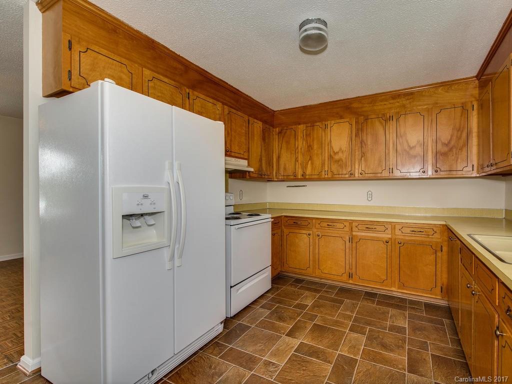 5117 Austin Road Monroe, NC 28112 - Photo 6 of 19 a kitchen with a refrigerator sink and cabinets