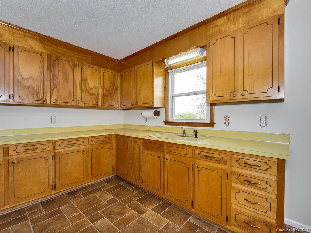 5117 Austin Road Monroe, NC 28112 - Photo 7 of 19 a kitchen with sink cabinets and window