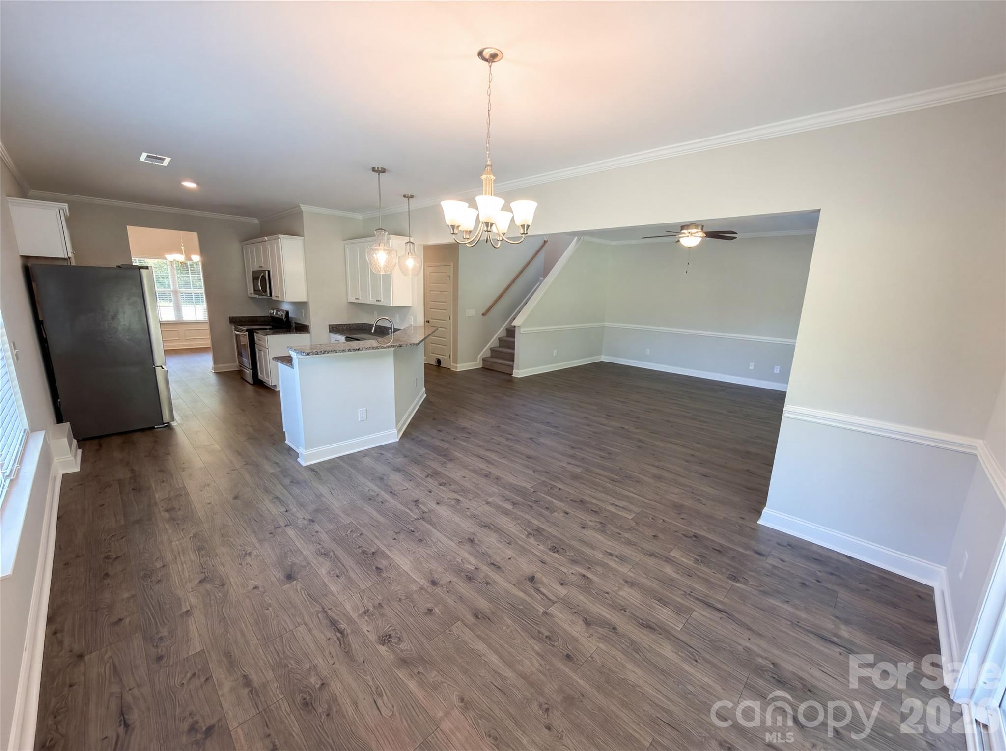 4918 Griffith Road Monroe, NC 28112 - Photo 8 of 17 a view of a living room and kitchen with wooden floor