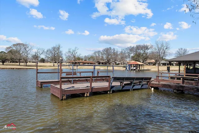 a view of a lake with couches in the patio