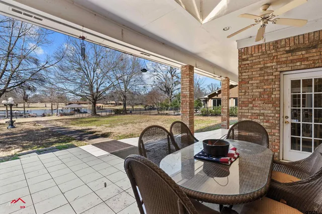 a view of a patio with table and chairs
