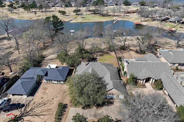 an aerial view of a house with a lake view