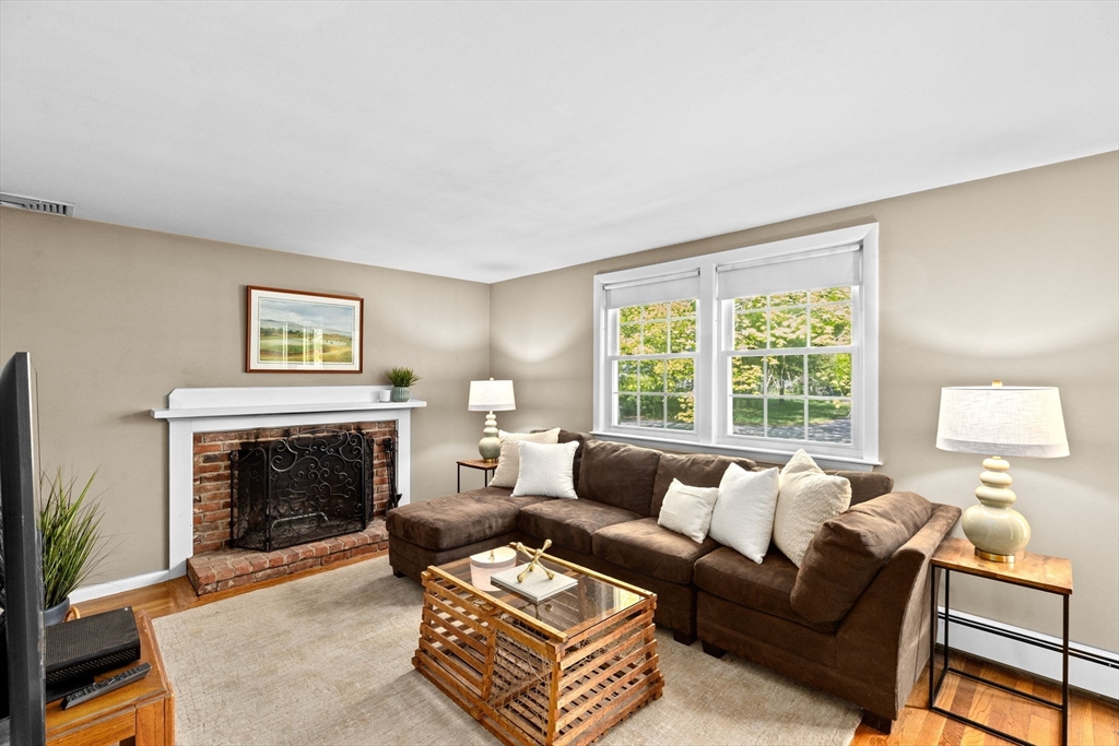 154 Mann Road Scituate, MA 02066 - Photo 11 of 34 a living room with furniture and a fireplace