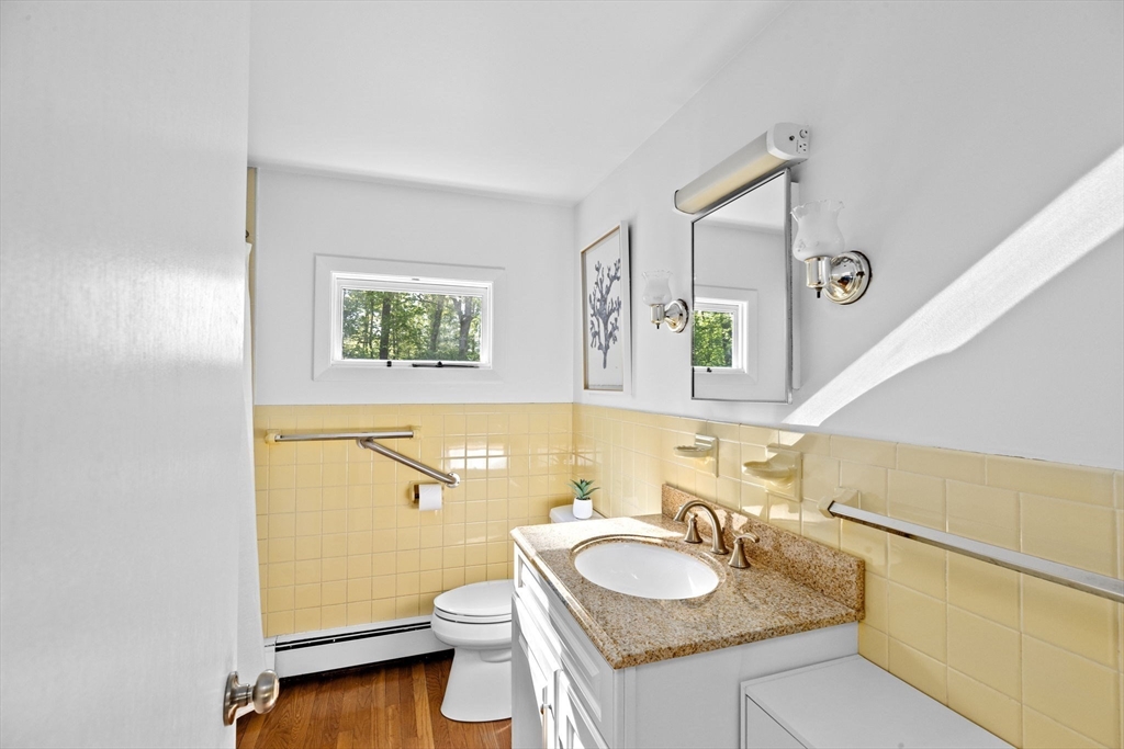 154 Mann Road Scituate, MA 02066 - Photo 13 of 34 a bathroom with a granite countertop toilet sink and mirror