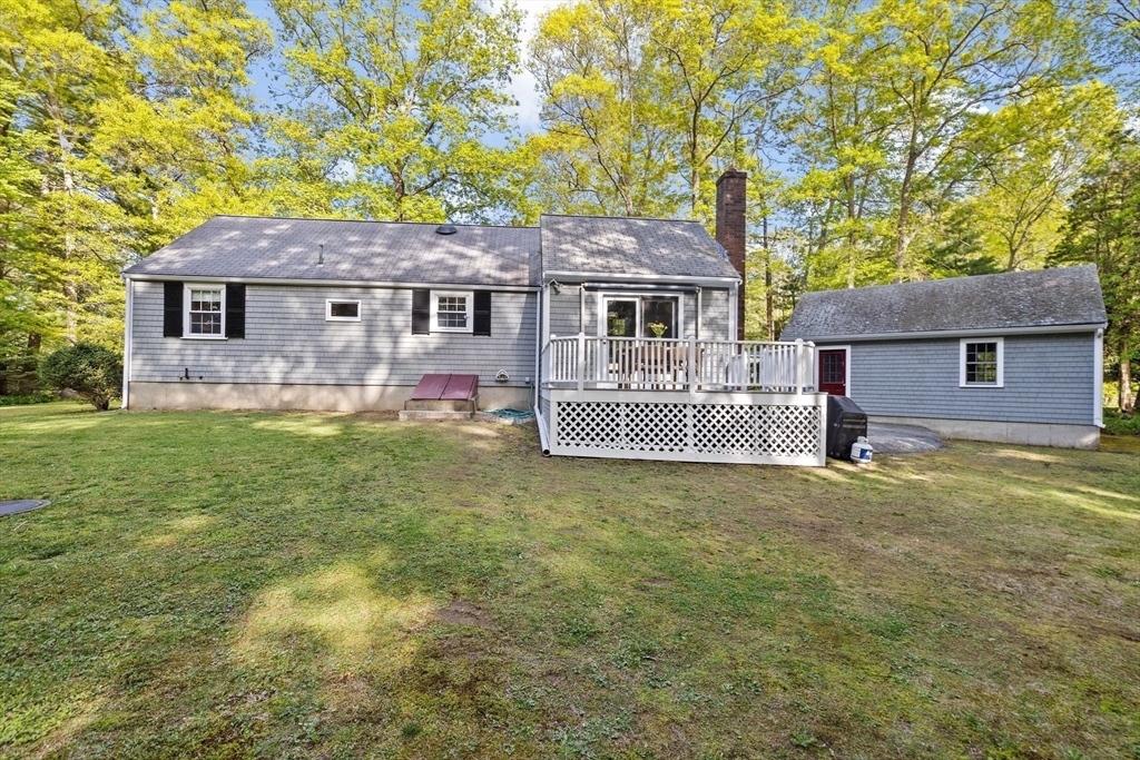 154 Mann Road Scituate, MA 02066 - Photo 26 of 34 a front view of a house with a garden and yard