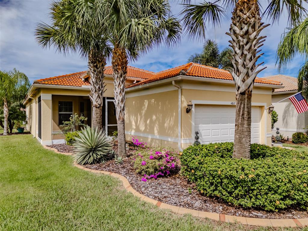 4817 Sandy Glen Way Wimauma, FL 33598 - Photo 1 of 1 a front view of a house with a garden
