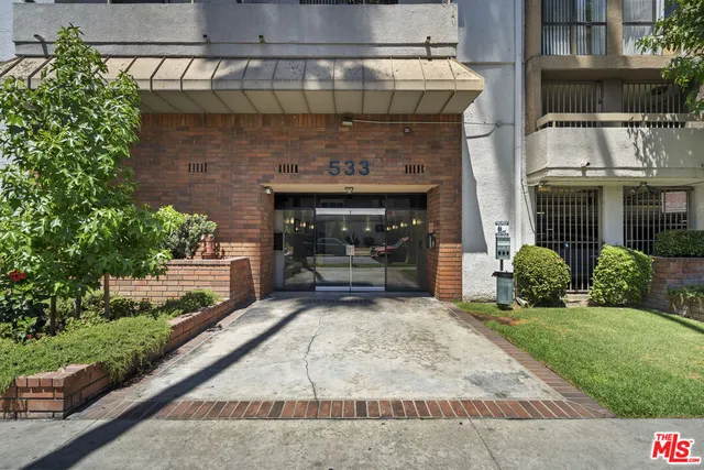 a white building with a bench in front of house