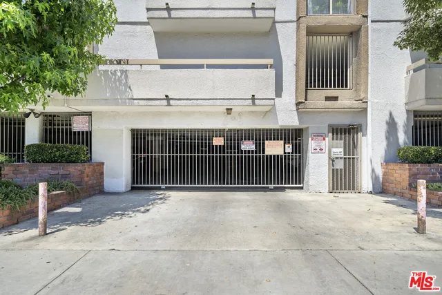 a view of a street with potted plants