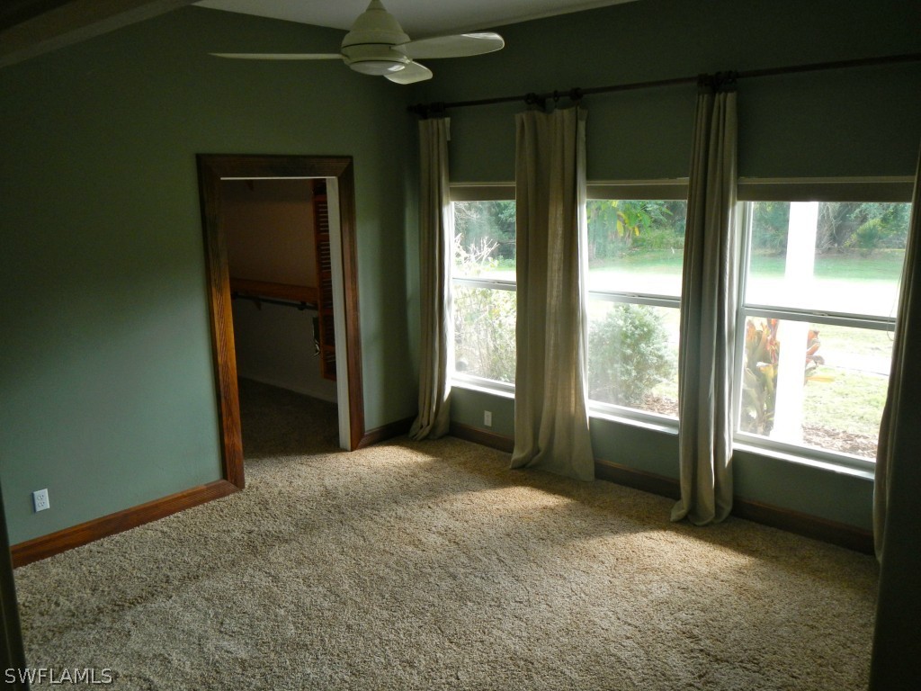 20150 North River Road Alva, FL 33920 - Photo 17 of 25 a view of an empty room with a fireplace and a window