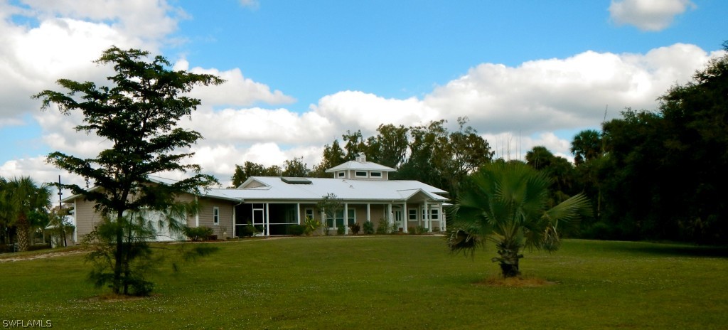 20150 North River Road Alva, FL 33920 - Photo 2 of 25 a front view of a house with a garden