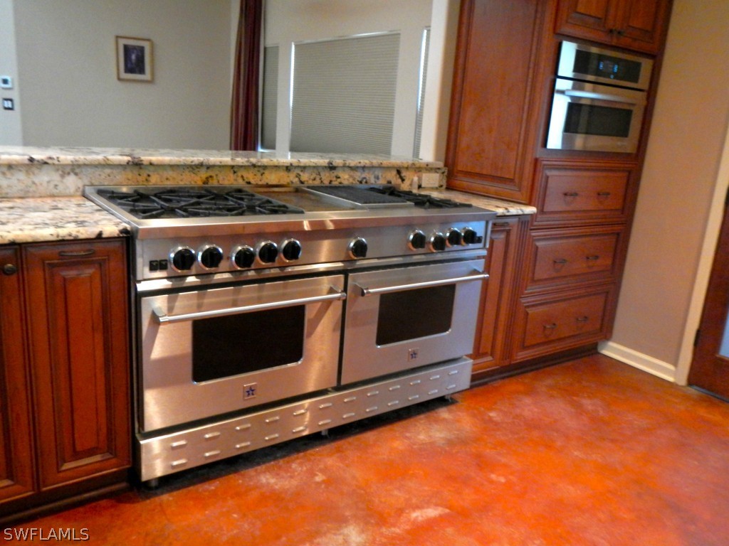 20150 North River Road Alva, FL 33920 - Photo 8 of 25 a stove top oven sitting inside of a kitchen