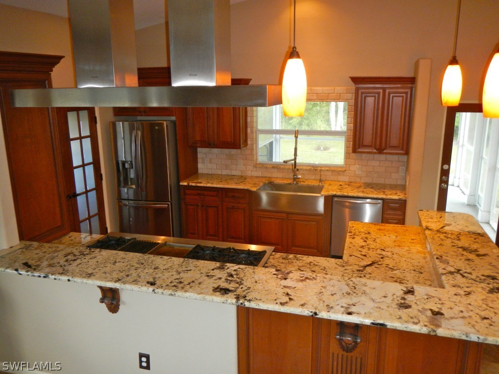 20150 North River Road Alva, FL 33920 - Photo 10 of 25 a view of kitchen island a sink wooden floor and a window