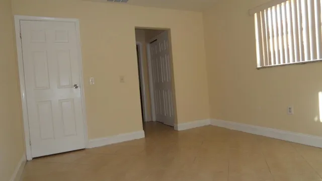 an empty room with windows and closet